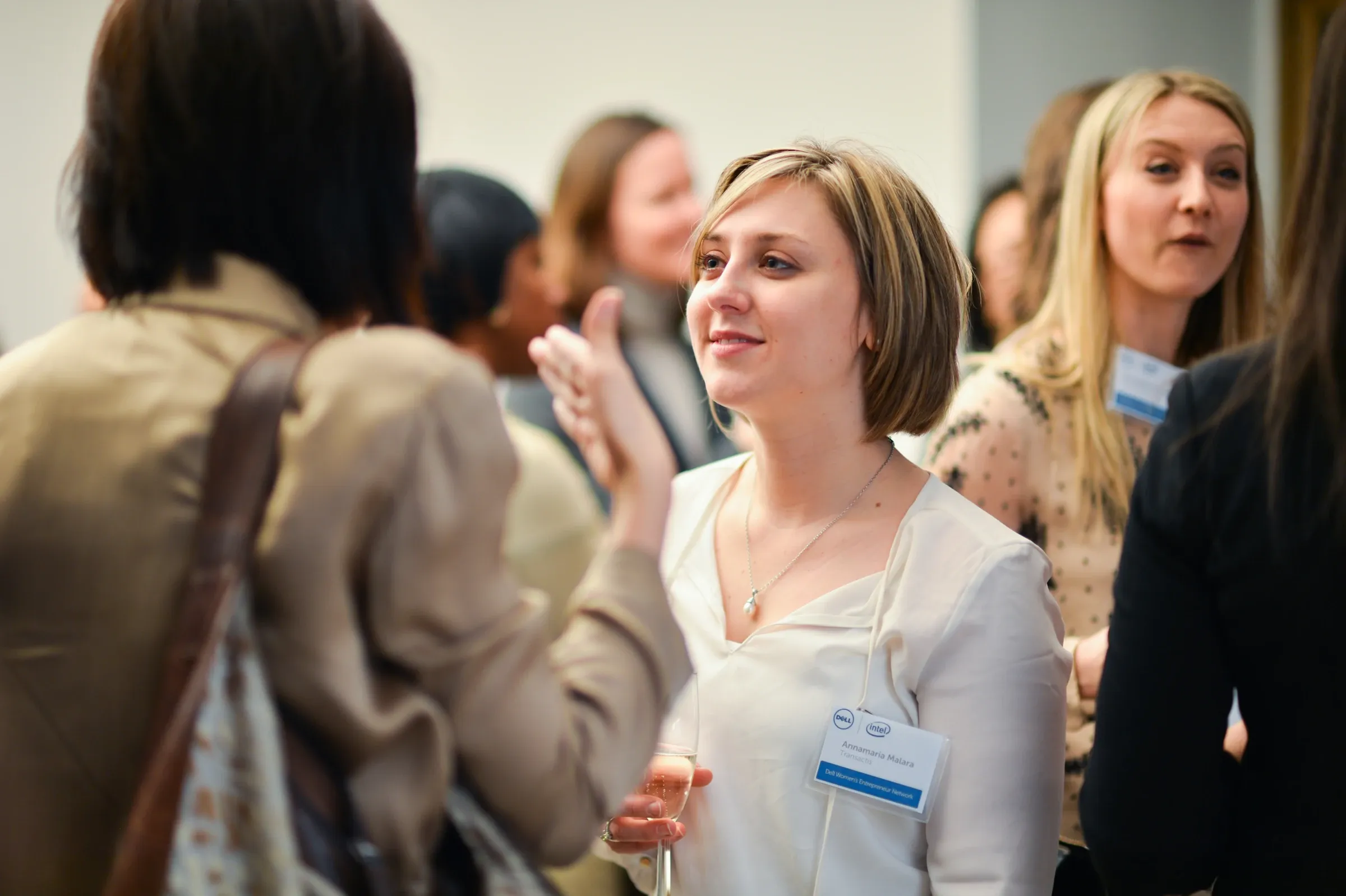 Attendees networking at a Dell Women's Entrepreneur Network event in New York City.